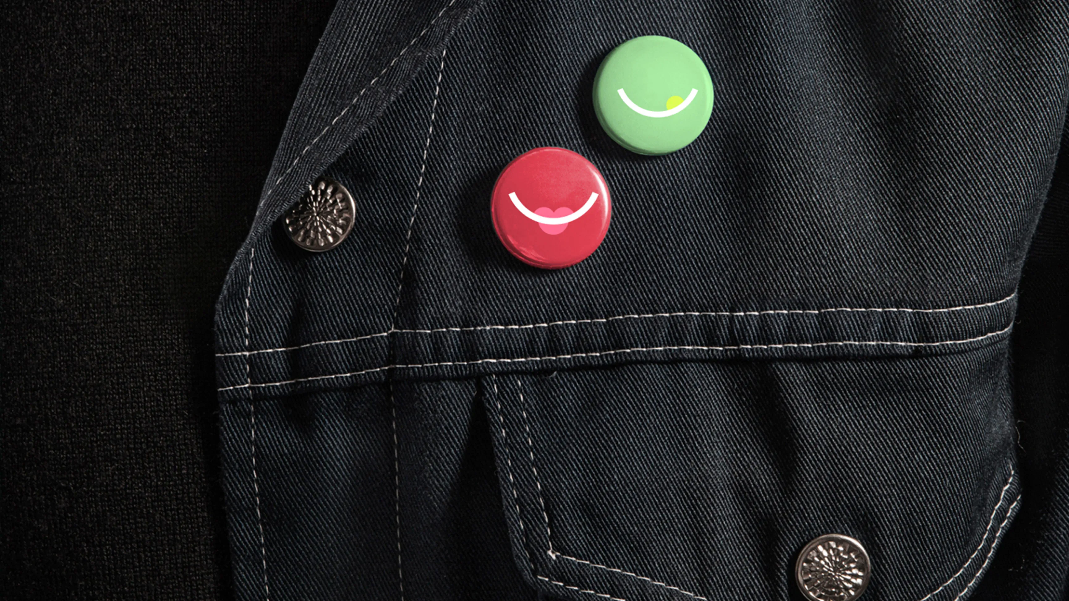 Black shirt and jean jacket with smiles pins attach to it