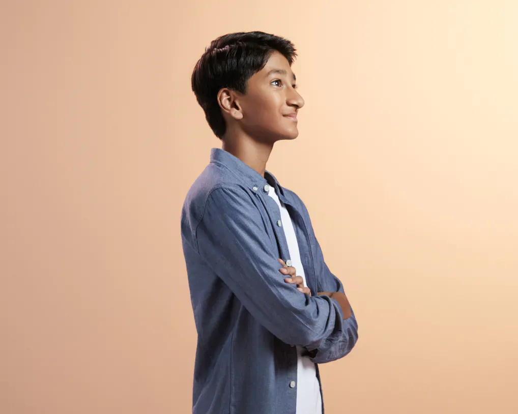 Portrait of boy on light orange background