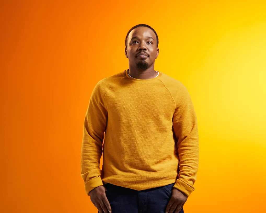 Portrait of man on bright orange background