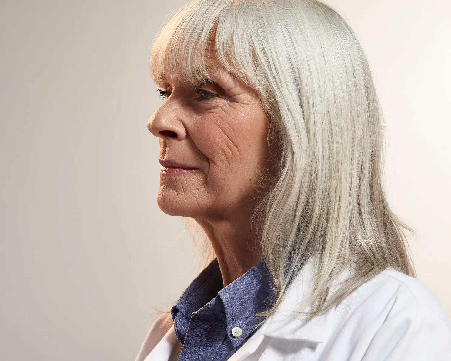 Portrait of woman lab work on a tan background