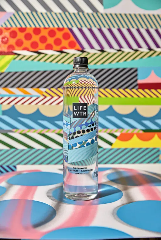 LIFEWTR bottle on a multi color mural