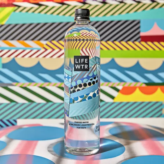 LIFEWTR bottle on a multi color mural